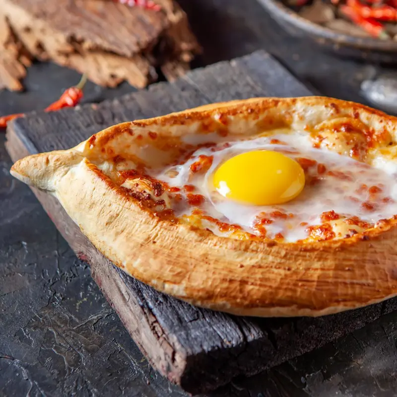 Adjarian khachapuri: boat-shaped bread with cheese and egg yolk