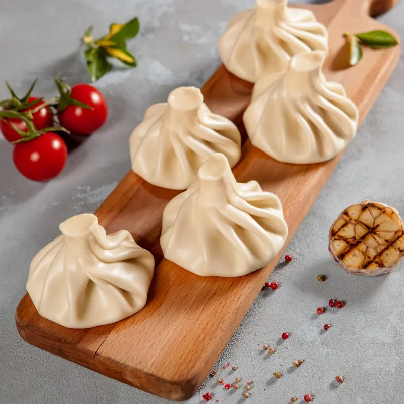 Khinkali with meat on a wooden board