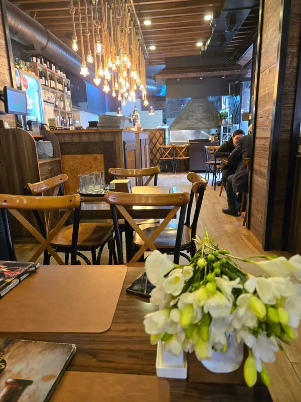 The bar under a cluster of Edison bulbs